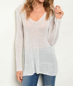 Long sleeve V-neck semi-sheer knit sweater top.